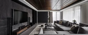 Modern living room featuring black walls, glass elements, and concrete flooring.
