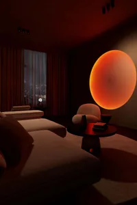 Contemporary living room with orange circular light fixture, white sectional sofa, and minimalist decor.