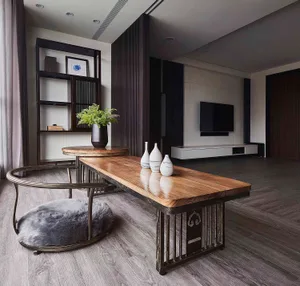 A modern living room featuring wooden furniture and metal tables with decorative vases.