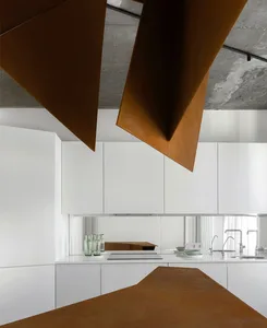 Modern kitchen featuring metal elements and white cabinets.