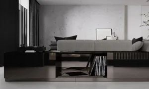 A modern minimalist living space featuring a concrete wall and black coffee table.