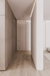 Minimalist bedroom featuring wooden floors, concrete walls, and a sleek design.