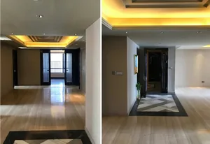 Modern living room entry with wooden flooring and marble accents