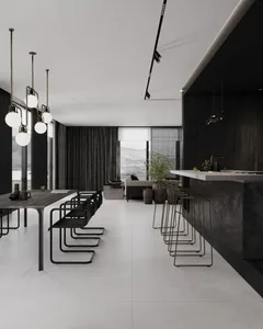 A modern minimalist kitchen featuring a white marble countertop and white marble floor tiles, with a sleek black kitchen isla