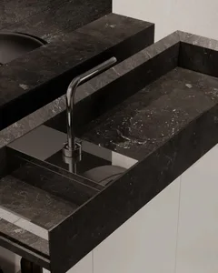 A modern luxury kitchen with a marble countertop and sink.