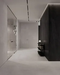 Modern minimalist corridor featuring black marble and concrete materials.