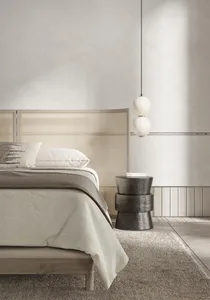 Minimalist bedroom with wooden bed frame, fabric bedding, and metallic side table
