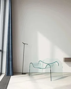 Minimalist living room featuring a glass chair with a sleek, transparent design.