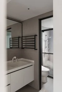 Modern bathroom with concrete walls, white vanity, and glass shower enclosure.