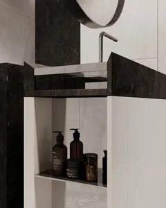 Modern bathroom featuring a marble and concrete sink with a black faucet and minimalist design.