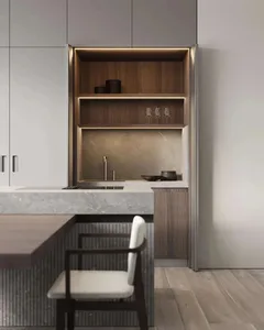 Close-up view of a modern kitchen with marble countertops and walnut cabinets.