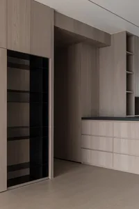 An interior design featuring a modern closet space with light-wood cabinets and shelves.