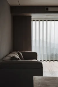 Modern living room featuring a neutral-toned sofa and wooden floor
