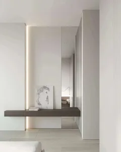 Modern minimalist entryway featuring white walls, wooden floor, glass door, and metal accents.