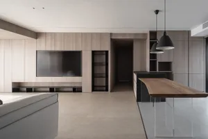 Modern minimalist kitchen with open-concept design, featuring wooden textured cabinets and concrete flooring.