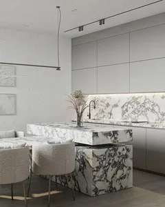 Modern, minimalist residential kitchen with a marble island, pendant lights, and sleek white cabinets.