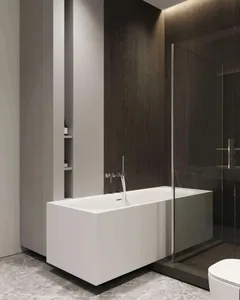Modern bathroom featuring white concrete bathtub, glass shower enclosure, and wooden elements