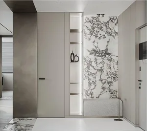 Modern entryway featuring white marble tiles and a shelf with black vases.