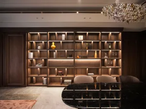 Luxurious living room with wooden shelves displaying various decorative items and lighting focused on the shelves.