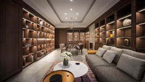 A modern living room with a marble coffee table, wooden shelves, and a leather sofa.