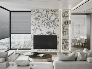 A minimalist living room with marble and glass elements.