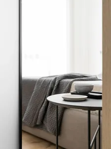 A minimalist living space with fabric and metal elements.