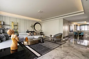 Modern minimalist living room featuring a marble floor and contemporary furniture.
