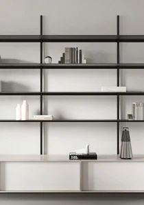 A minimalist metal shelf with books and decorative objects.
