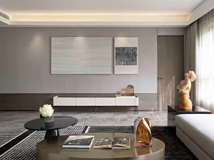 Contemporary living room with modern furniture and minimalist design in neutral tones, featuring abstract wall art and a slee