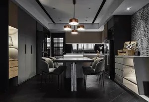 Modern, minimalist kitchen featuring metallic black cabinets and a marble countertop.