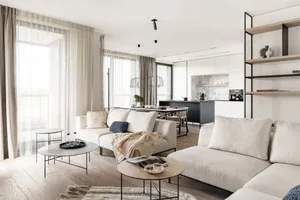 Modern living room with neutral-toned furniture and decor, natural light, and open floor plan.