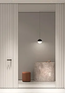 Modern minimalist interior design featuring a marble floor, sleek white panels, and minimalist pendant light.