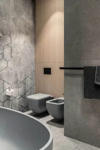 Modern bathroom featuring concrete and wood materials with a metallic finish.