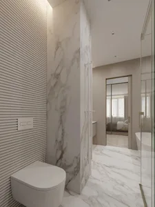 Modern bathroom featuring marble finishes and fixtures.