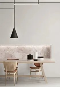 A modern dining room featuring a wooden table with marble top and chairs, minimalist lighting, and minimalist decor.