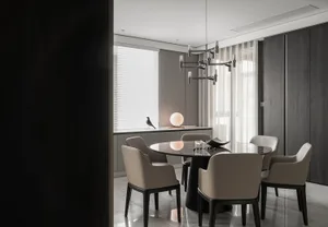 Modern kitchen with marble countertop and black seating area.