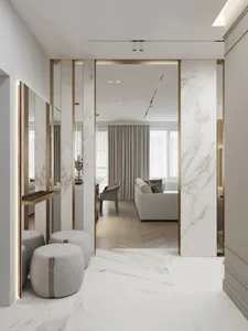 Modern living room with white marble walls and floor, featuring a sofa and chairs.