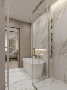 Modern minimalist bathroom with white freestanding bathtub and marble walls and floor.