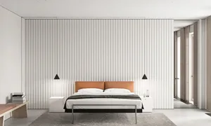 Minimalist bedroom with a orange headboard, white walls, and metallic frame bed.