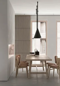 Modern dining room with minimalist design, featuring a wooden dining table, chairs, and pendant light against a concrete wall
