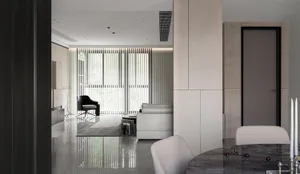 Modern minimalist living room with concrete, glass, and metal materials.