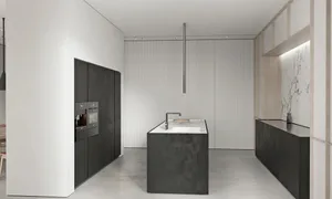A modern kitchen with a central island featuring a concrete countertop and floor-to-ceiling cabinets.