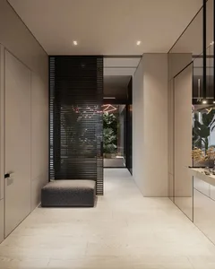 Modern, minimalist entrance hallway with wooden flooring and metal accents.