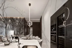Modern kitchen featuring a marble backsplash and countertop