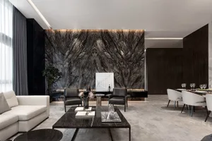 Modern living room with marble accent wall, leather furniture, and minimalist decor.
