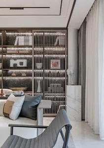 Modern living room featuring metal bookshelves, marble accents, and fabric seating.