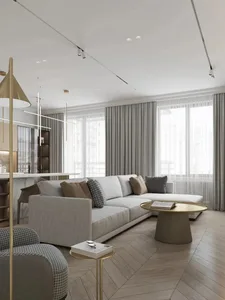 Modern, minimalist living room with fabric sofa, glass coffee table, and metal accents.