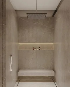 Modern, minimalist bathroom shower with marble walls and a built-in bench.
