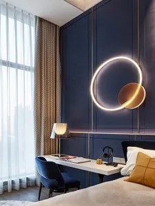 A modern bedroom featuring a white wall, wooden furniture, and a sleek desk setup.