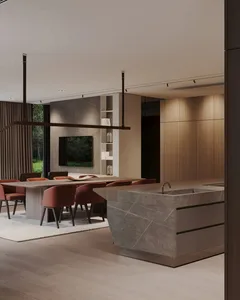 Modern kitchen featuring marble countertops, wood flooring, and dining area.